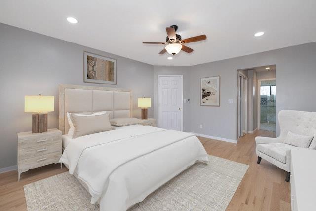 bedroom with ceiling fan and light hardwood / wood-style floors