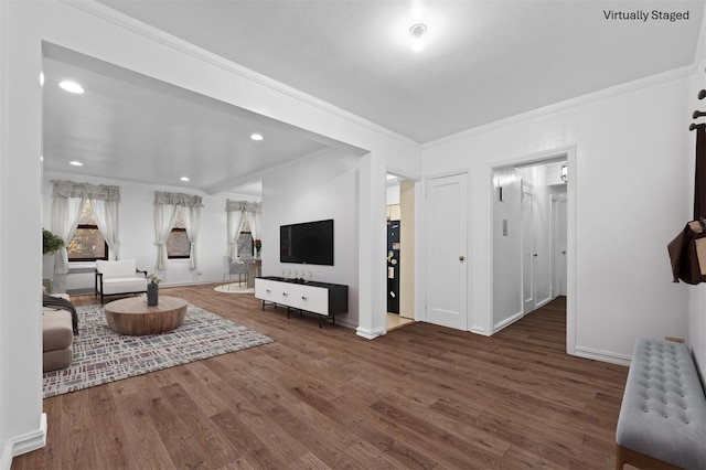 living room featuring radiator, dark hardwood / wood-style flooring, and ornamental molding