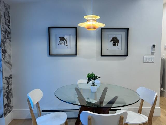 dining area featuring hardwood / wood-style flooring and a baseboard radiator