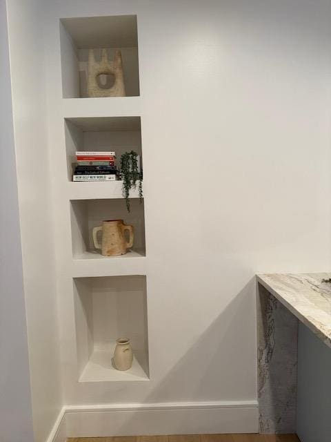 room details featuring built in shelves and hardwood / wood-style floors