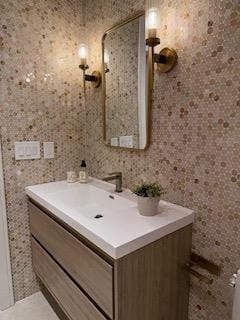 bathroom featuring tile walls and vanity