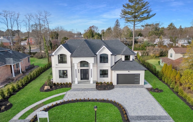 view of front facade with a garage and a front lawn