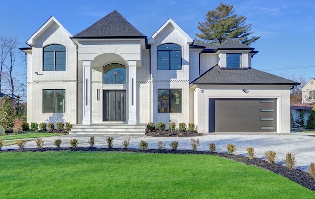 french provincial home with a front yard and a garage