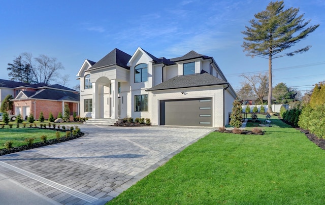 view of front of home featuring a garage and a front lawn