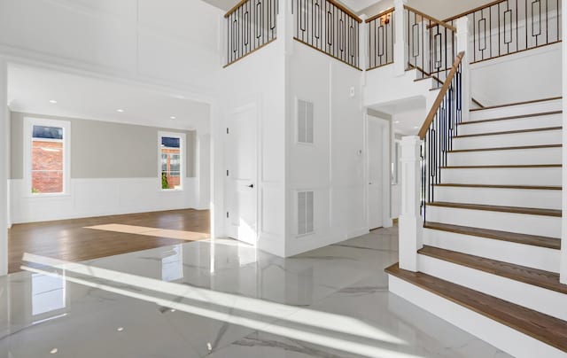 stairs featuring a towering ceiling