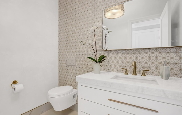 bathroom with vanity, tasteful backsplash, and toilet