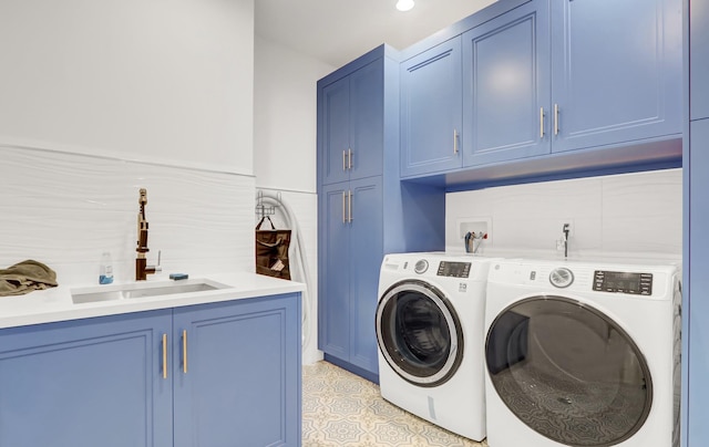 laundry area with cabinets, separate washer and dryer, and sink