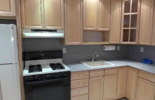 kitchen with backsplash, light brown cabinets, white appliances, and sink