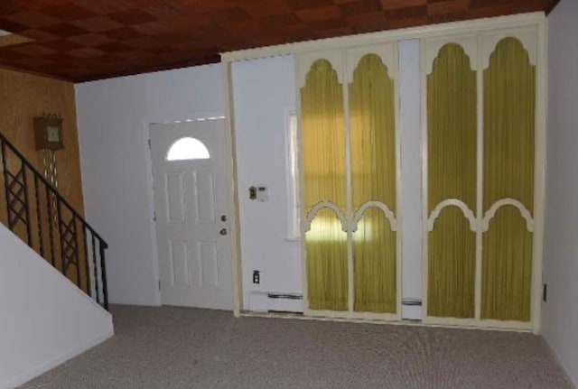 foyer entrance featuring carpet and a baseboard radiator