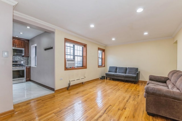 living room featuring crown molding, cooling unit, a baseboard radiator, and light wood-type flooring