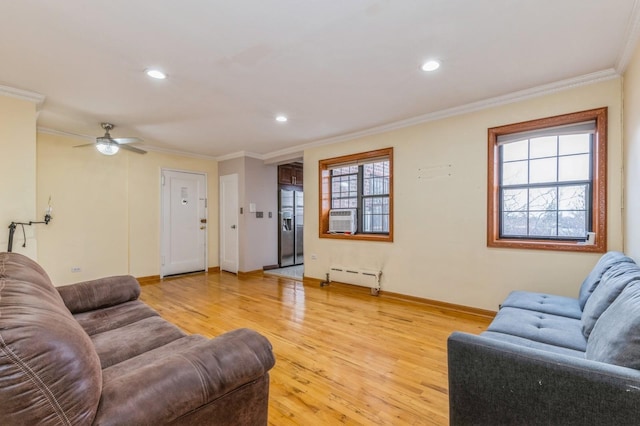living room featuring crown molding, plenty of natural light, ceiling fan, and light hardwood / wood-style floors