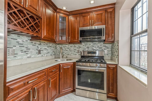 kitchen featuring decorative backsplash, sink, and stainless steel appliances