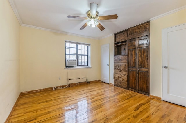 unfurnished bedroom featuring light hardwood / wood-style floors, baseboard heating, ornamental molding, and ceiling fan