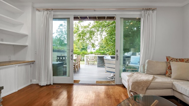 entryway featuring wood-type flooring and crown molding