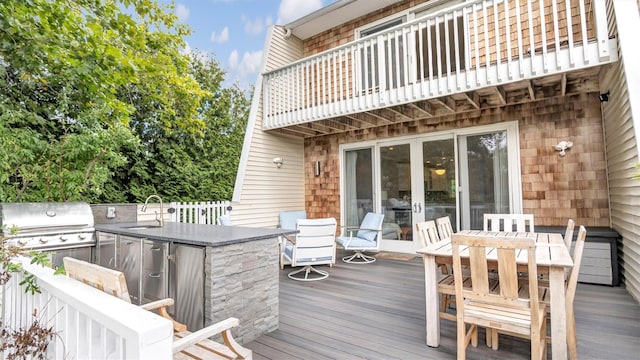 wooden terrace with an outdoor wet bar, grilling area, and area for grilling