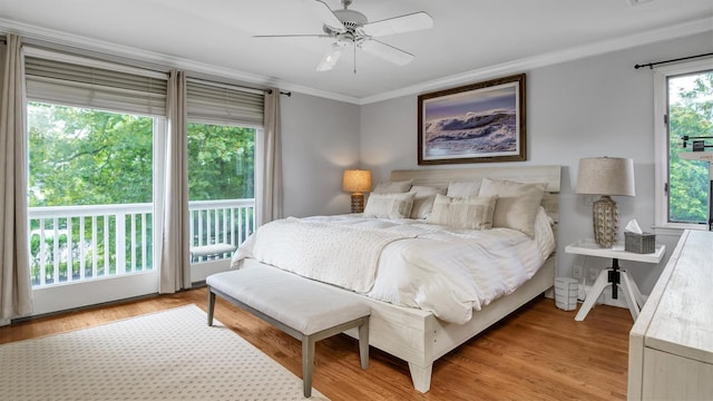 bedroom featuring ceiling fan, crown molding, and light hardwood / wood-style flooring