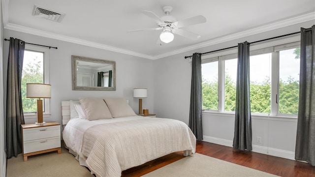 bedroom featuring ceiling fan, dark wood-type flooring, and ornamental molding