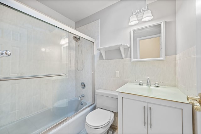 full bathroom with vanity, toilet, enclosed tub / shower combo, and tile walls