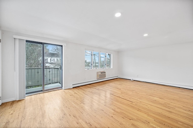 unfurnished room with a baseboard radiator and light hardwood / wood-style flooring