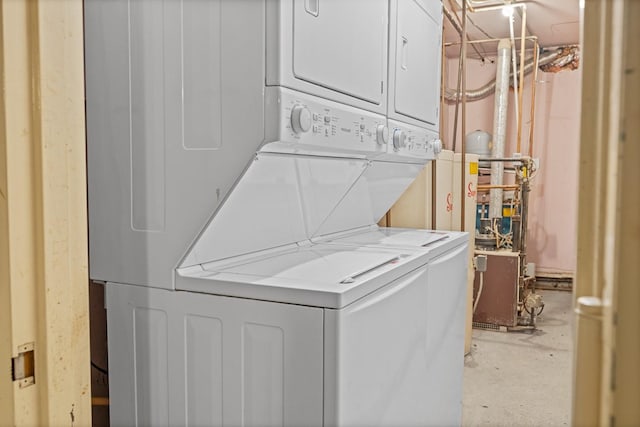 washroom with stacked washing maching and dryer