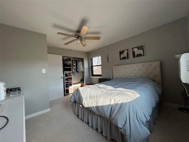 carpeted bedroom featuring a closet and ceiling fan