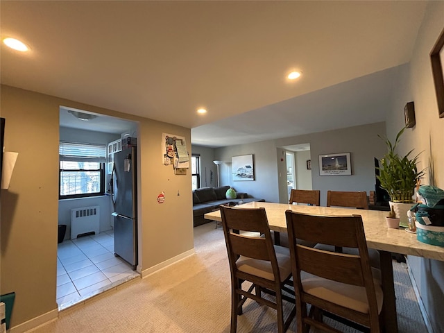 carpeted dining area featuring radiator heating unit