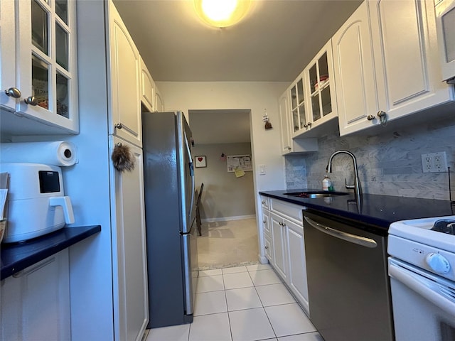 kitchen featuring backsplash, sink, white cabinets, and appliances with stainless steel finishes