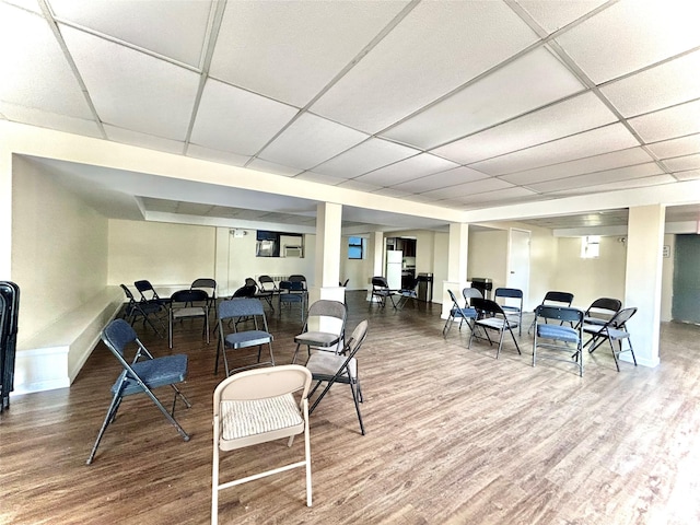 interior space featuring a drop ceiling and wood-type flooring