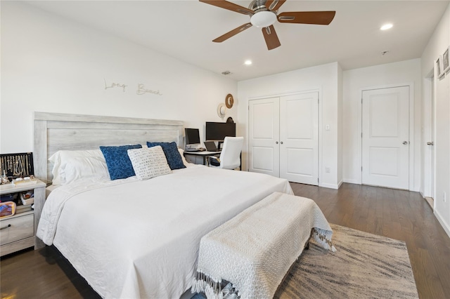 bedroom featuring a closet, dark hardwood / wood-style floors, and ceiling fan