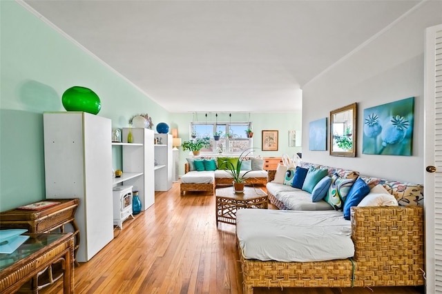 living room featuring hardwood / wood-style floors and crown molding