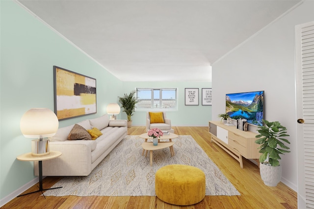 living room with light hardwood / wood-style flooring and crown molding