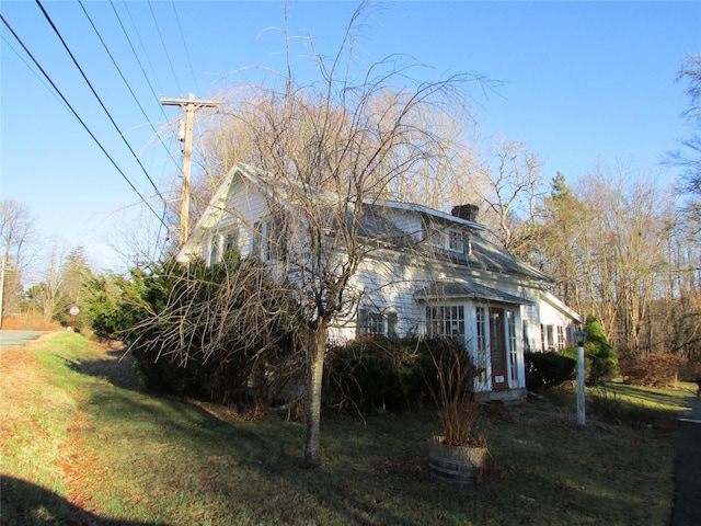 view of side of property with a lawn