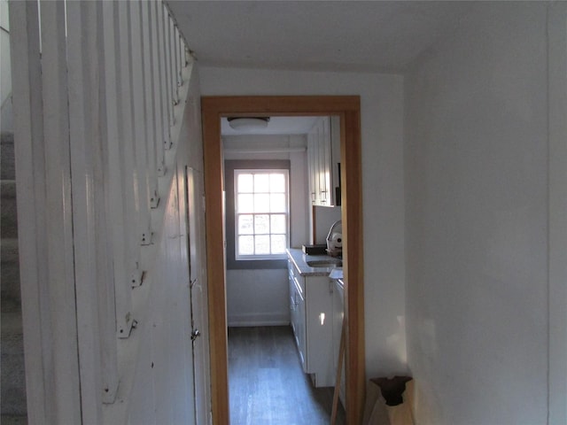 hall with hardwood / wood-style floors and sink