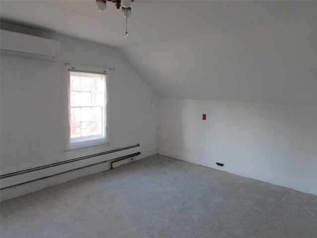 additional living space featuring a wall unit AC, carpet, vaulted ceiling, and a baseboard heating unit