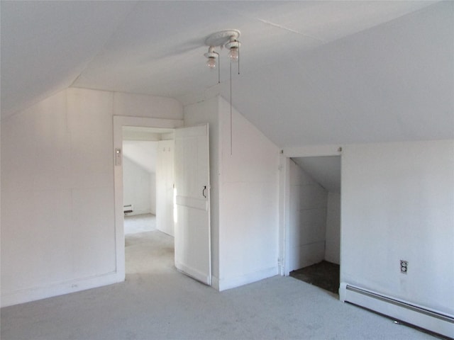 bonus room featuring light carpet, lofted ceiling, and a baseboard heating unit