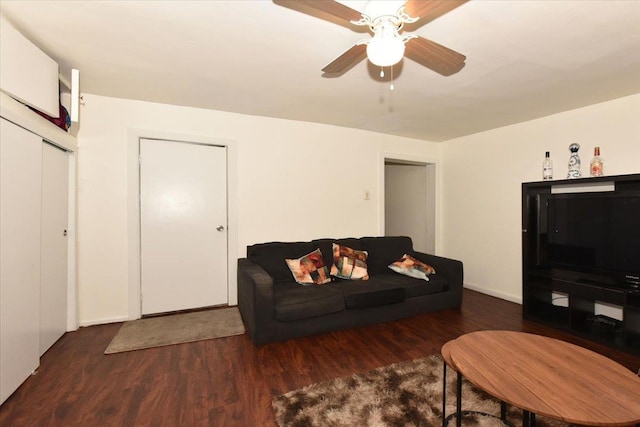 living room featuring dark hardwood / wood-style floors and ceiling fan