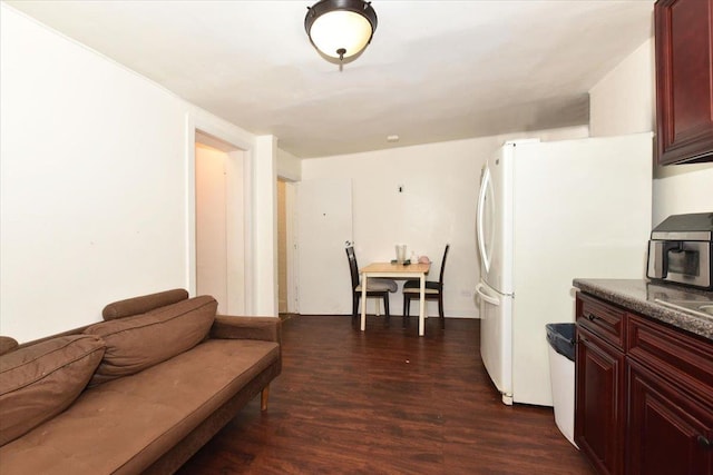 kitchen with dark hardwood / wood-style flooring and white refrigerator