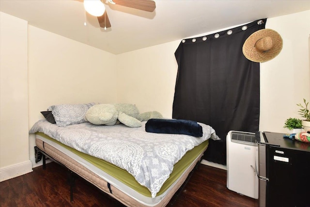 bedroom featuring ceiling fan and dark wood-type flooring