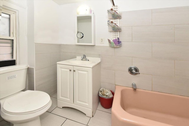 bathroom with tile patterned floors, vanity, tile walls, and toilet