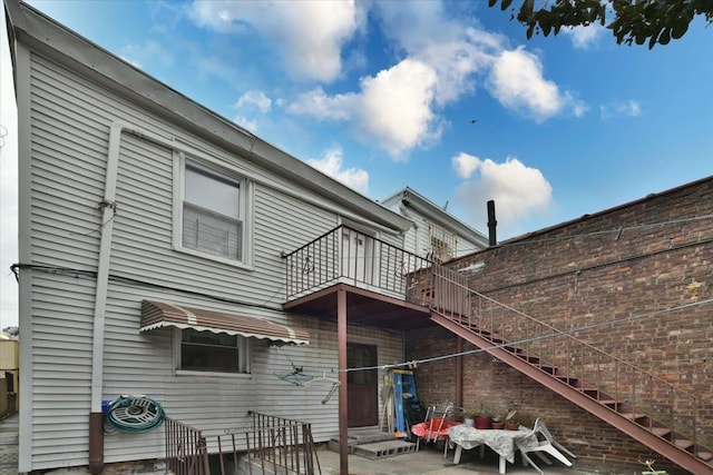 back of house featuring a patio area and a balcony