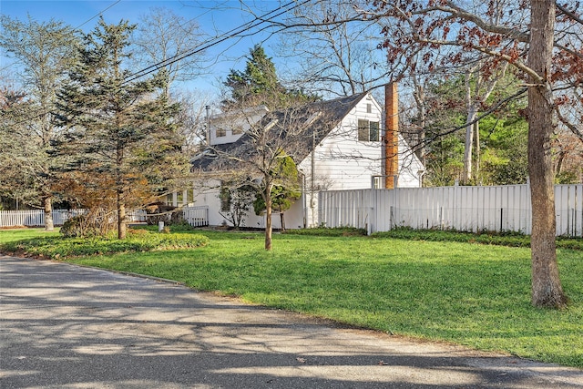 view of property exterior featuring a lawn