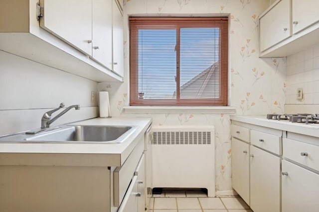 kitchen with white cabinets and radiator