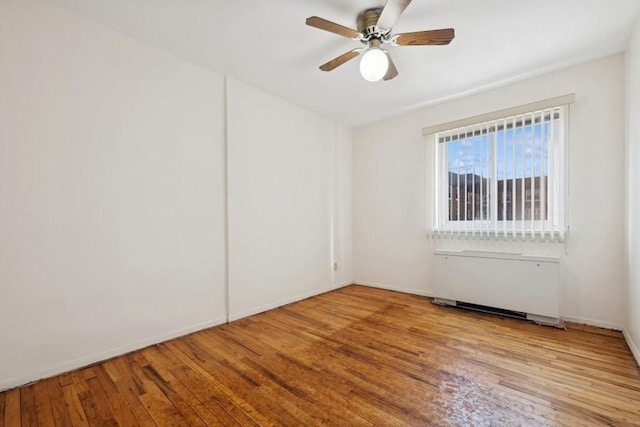 empty room with light hardwood / wood-style flooring and ceiling fan