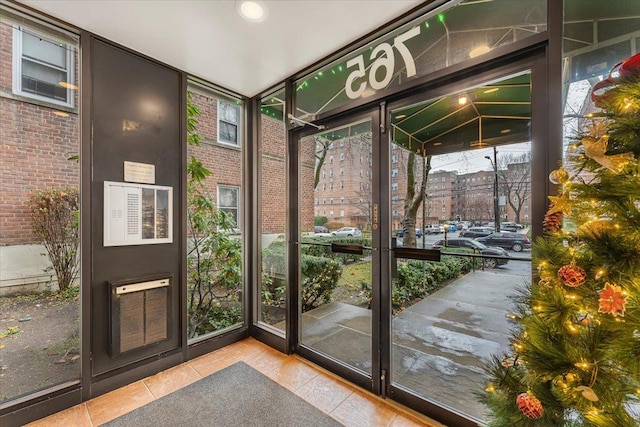 doorway to outside featuring vaulted ceiling and floor to ceiling windows