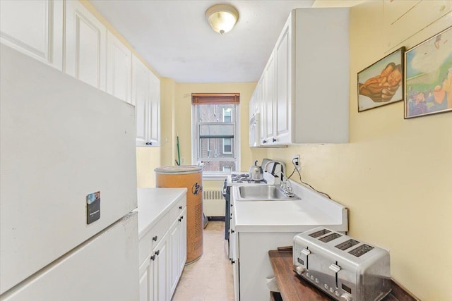 clothes washing area with radiator heating unit and sink