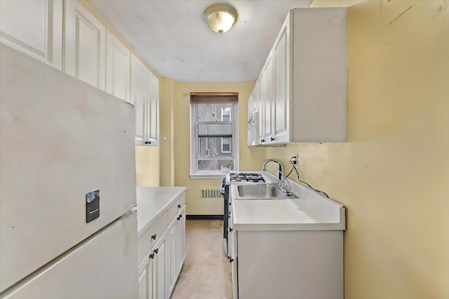 clothes washing area featuring radiator and sink