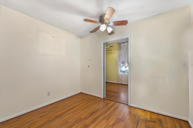 unfurnished bedroom featuring ceiling fan, a closet, and wood-type flooring