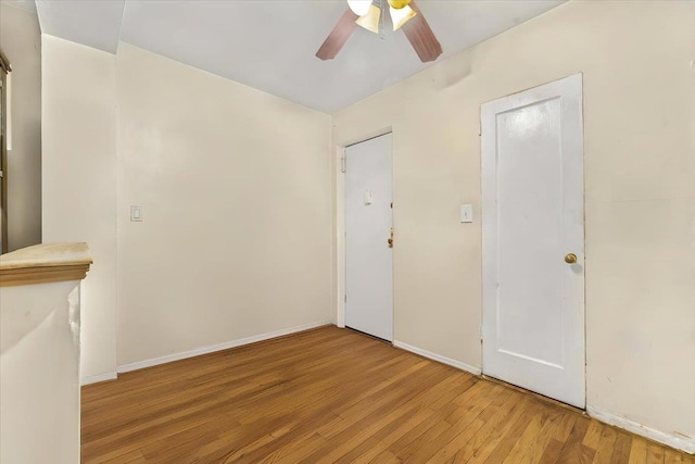 spare room with ceiling fan and light wood-type flooring