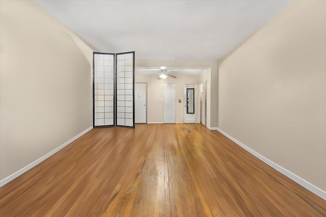 unfurnished room featuring light hardwood / wood-style flooring and ceiling fan