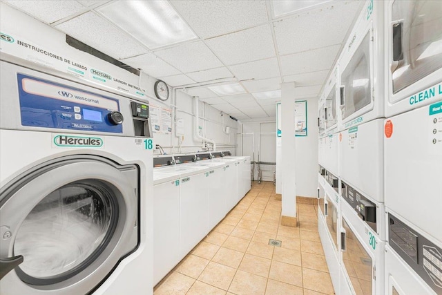 laundry room with washing machine and dryer, stacked washer and clothes dryer, and light tile patterned flooring